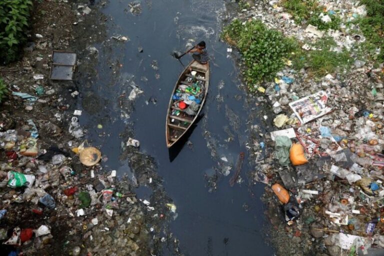 A small boat navigating through a polluted river filled with plastic in our oceans, showing severe waste accumulation along the banks.