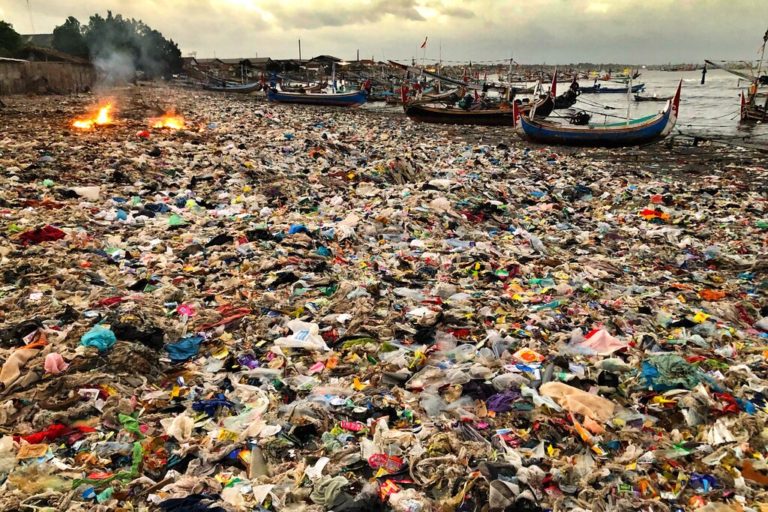 Beach covered with plastic waste illustrating plastic pollution statistics – severe plastic pollution impacting oceans and communities