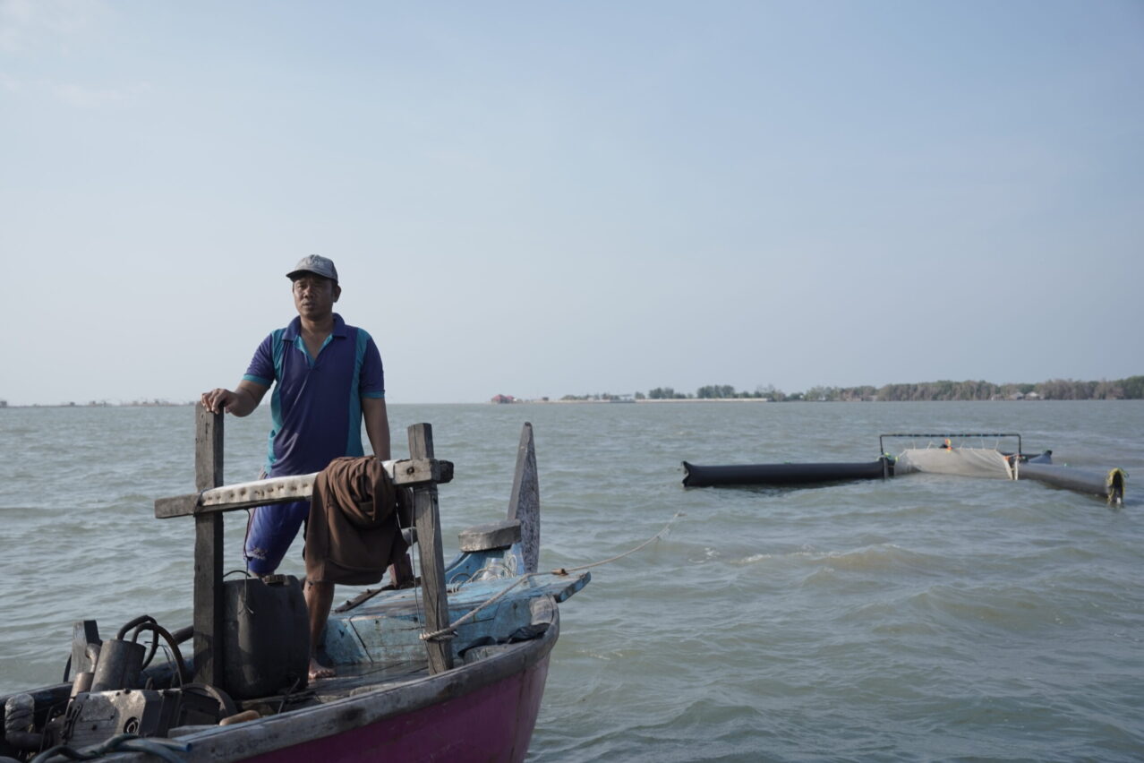 Fisherman using a specialized equipment to collect marine plastic waste for Ocean Material plastic credits