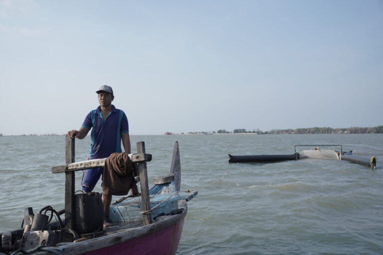 Fisherman using a specialized equipment to collect marine plastic waste for Ocean Material plastic credits