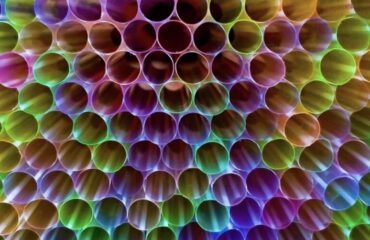 Misleading Eco-Friendly Products Colorful plastic straws illustrating greenwashing in eco-friendly innovations and how single-use items can mislead consumers about sustainability.